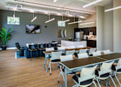 Thumbnail 24 of 116 - A conference room with a long table and chairs.