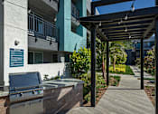 Thumbnail 2 of 116 - A patio with a grill and a pergola.