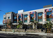 Thumbnail 14 of 116 - A modern building with a colorful mural on the side.