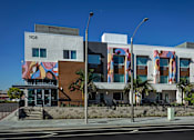 Thumbnail 9 of 116 - A modern building with a mural on the side and the number 1108 on the top left.