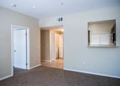 Thumbnail 28 of 36 - A room with a white door, a window with blinds, and a wall-mounted TV.