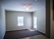Thumbnail 22 of 36 - A room with a carpeted floor and a ceiling light.
