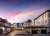 Thumbnail 106 of 114 - A residential area with apartment buildings and a driveway.