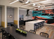 Thumbnail 88 of 114 - A modern dining area with a black table and chairs.