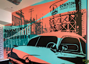 Thumbnail 93 of 114 - A Downtown Orange County mural with a black car in the foreground.