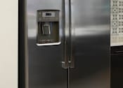 Thumbnail 89 of 114 - A stainless steel refrigerator with a water and ice dispenser on the door.