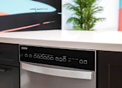 Thumbnail 92 of 114 - A modern stainless steel dishwasher with a digital display panel.