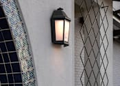 Thumbnail 85 of 114 - A black lantern is mounted on a white wall.