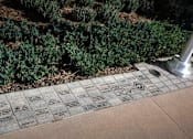 Thumbnail 51 of 114 - A plaque with names and symbols is placed on a ground.