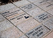 Thumbnail 42 of 114 - A brick with a plaque that says thank you for your service.