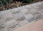Thumbnail 38 of 114 - A memorial plaque with names and messages engraved on it.