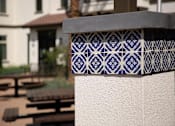 Thumbnail 44 of 114 - A blue and white tile is attached to a white wall.