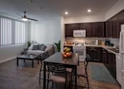 Thumbnail 5 of 114 - A modern kitchen with dark brown cabinets and a white refrigerator.