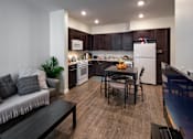 Thumbnail 2 of 114 - A modern kitchen with dark wood cabinets and a white refrigerator.