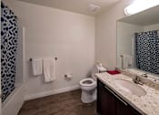 Thumbnail 4 of 114 - A bathroom with a toilet, sink, and shower.