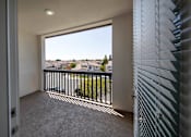 Thumbnail 1 of 114 - A balcony with a view of a residential area.
