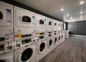 Thumbnail 6 of 114 - A row of washing machines in a laundromat.