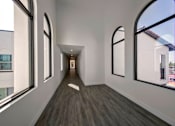 Thumbnail 13 of 114 - A long corridor with windows on both sides.