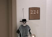 Thumbnail 8 of 114 - A door decorated with a skeleton figure and a number 224 on the wall.