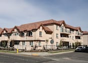 Thumbnail 2 of 2 - Apartment building with red roofs and white walls.