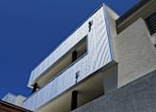 Thumbnail 4 of 103 - A modern building with a blue sky in the background.