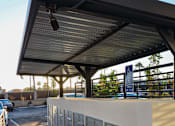 Thumbnail 69 of 103 - A parking garage with a white wall and a blue sign.