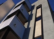 Thumbnail 73 of 103 - A modern building with a blue sky in the background.