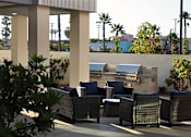 Thumbnail 61 of 103 - A patio with a couch, chairs and a table.