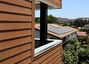 Thumbnail 65 of 103 - A brown building with a window and a view of the city.