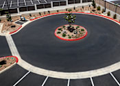 Thumbnail 59 of 103 - A roundabout with a tree in the center and a red ring around it.