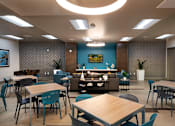 Thumbnail 43 of 103 - A modern dining area with tables and chairs.