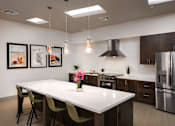 Thumbnail 36 of 103 - A modern kitchen with a white countertop and stainless steel appliances.