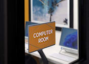 Thumbnail 45 of 103 - A sign that says Computer Room is on a stand in front of a computer.