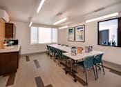 Thumbnail 40 of 103 - A conference room with a long table and chairs.