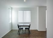 Thumbnail 23 of 103 - A dining room with a table and chairs.