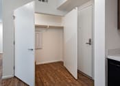 Thumbnail 100 of 103 - A white door is open to a room with wood flooring.