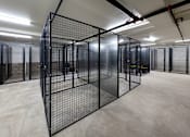 Thumbnail 81 of 103 - A large room with a black fence in the middle.