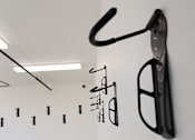 Thumbnail 93 of 103 - A black object is hanging on a white wall.