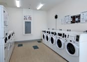 Thumbnail 102 of 103 - A row of washing machines in a laundromat.