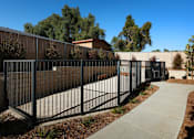 Thumbnail 55 of 103 - A black metal fence surrounds a building.