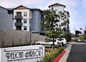 Thumbnail 93 of 94 - A street view of a residential area with a sign that reads "Pelican Harbor".