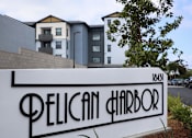 Thumbnail 76 of 94 - A sign that says Pelican Harbor in front of a building.