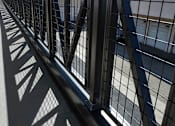 Thumbnail 87 of 94 - A metal fence with a shadow of a tree cast on the ground.