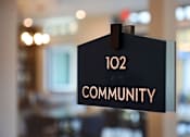 Thumbnail 72 of 94 - A sign that says "102 COMMUNITY" is hanging on a wall.