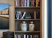 Thumbnail 63 of 94 - A bookshelf filled with books and decorative vases.