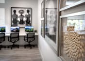 Thumbnail 45 of 94 - A modern office with a long table and chairs, and a framed picture of a tree on the wall.