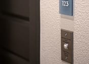 Thumbnail 23 of 94 - A door handle with a number plate of 123 and a button below it.