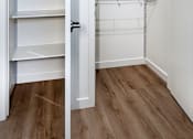 Thumbnail 16 of 94 - A white closet with shelves and a door open.