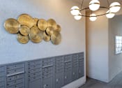 Thumbnail 22 of 94 - A wall of mailboxes with a row of gold circles above them.