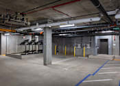Thumbnail 17 of 94 - A parking garage with concrete floors and multiple parking spaces.